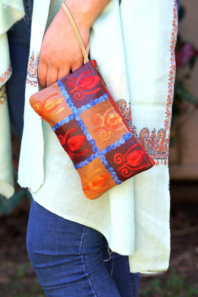 Vibrant colorful purse with kashmiri hand embroidery, has a secure zip top closure, ethically made in Nepal.