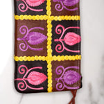 Vibrant colorful purse with kashmiri hand embroidery, has a secure zip top closure, ethically made in Nepal.