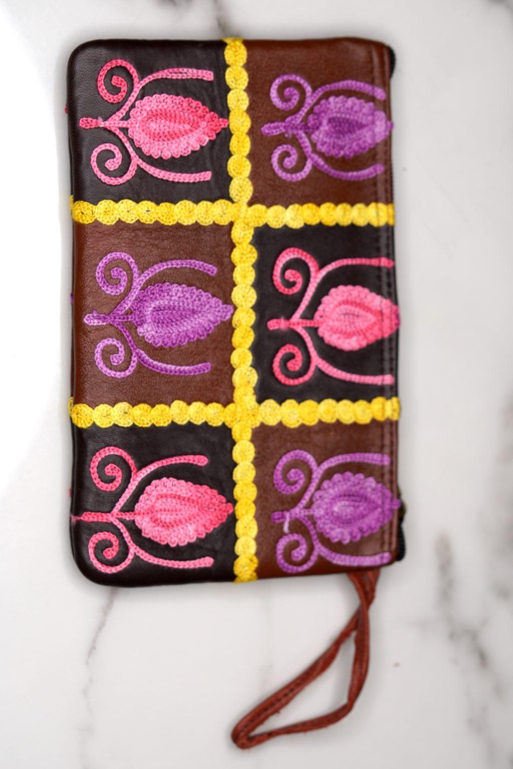 Vibrant colorful purse with kashmiri hand embroidery, has a secure zip top closure, ethically made in Nepal.