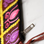 Vibrant colorful purse with kashmiri hand embroidery, has a secure zip top closure, ethically made in Nepal.
