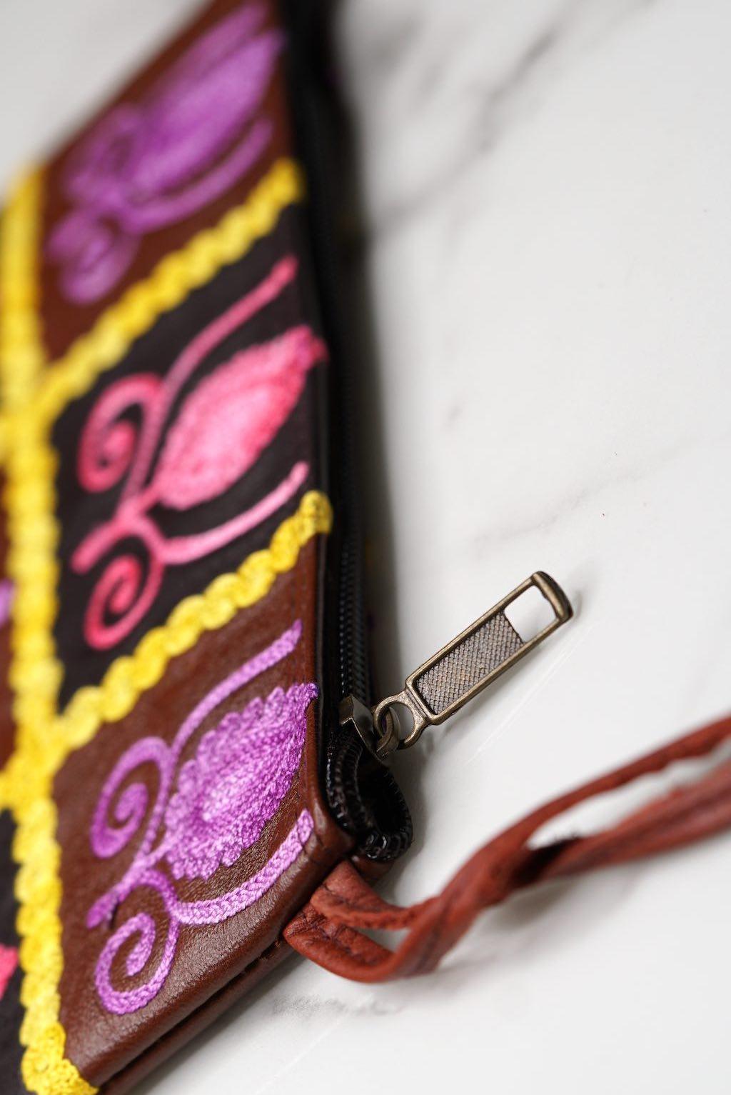 Vibrant colorful purse with kashmiri hand embroidery, has a secure zip top closure, ethically made in Nepal.