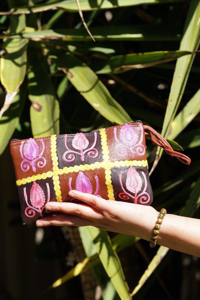 Vibrant colorful purse with kashmiri hand embroidery, has a secure zip top closure, ethically made in Nepal.