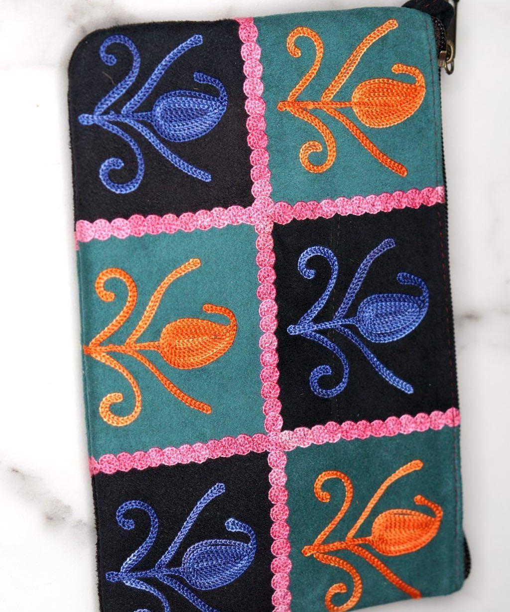 Unique style purse with cashmere handwork embroidery that comes with a wristlet and a secure zip top closure.