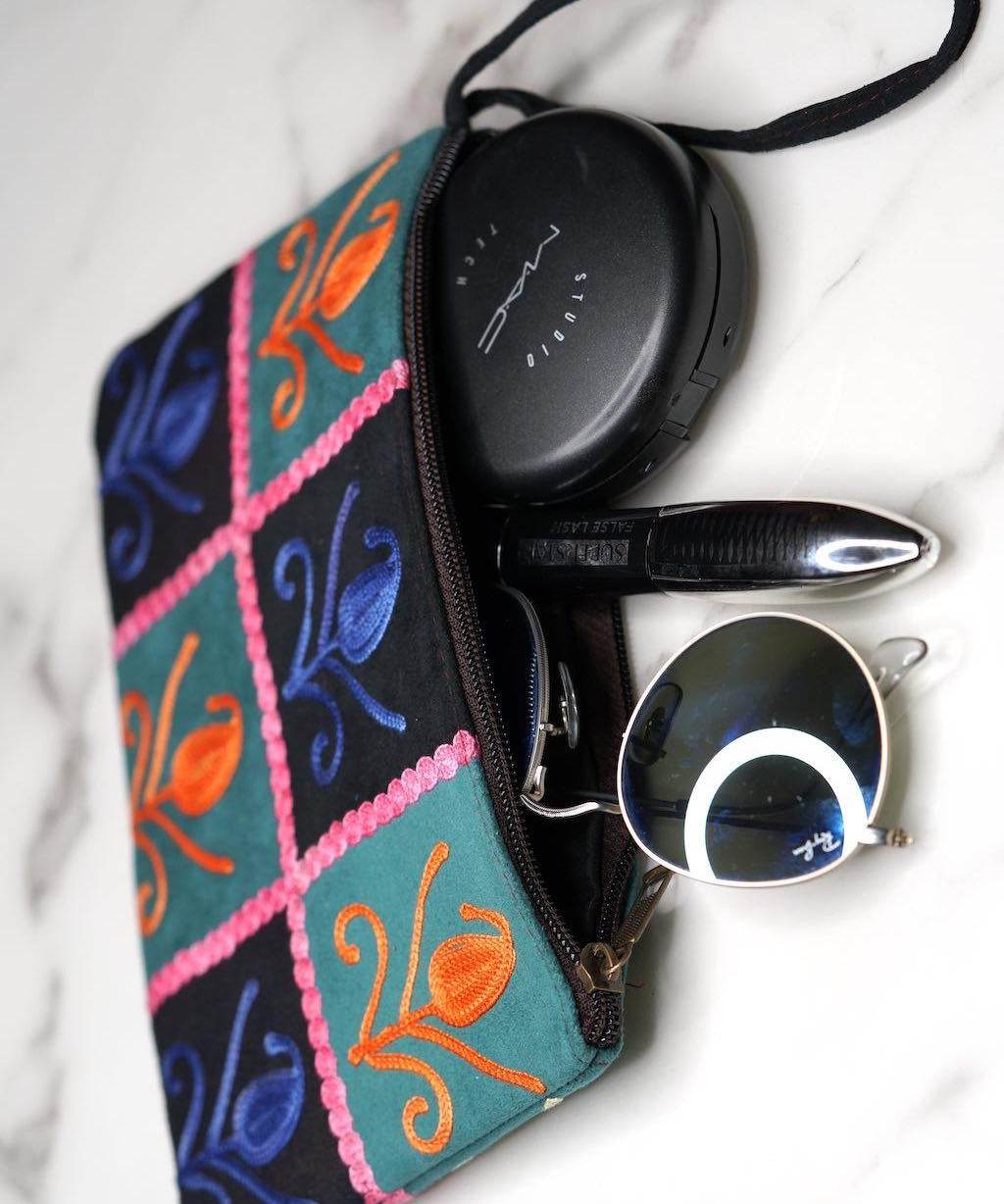 Unique style purse with cashmere handwork embroidery that comes with a wristlet and a secure zip top closure.