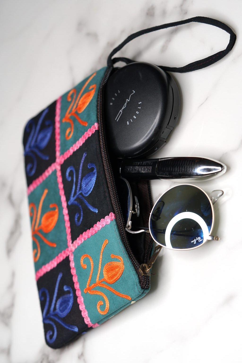 Unique style purse with cashmere handwork embroidery that comes with a wristlet and a secure zip top closure.