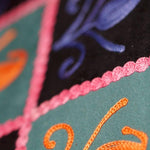 Unique style purse with cashmere handwork embroidery that comes with a wristlet and a secure zip top closure.