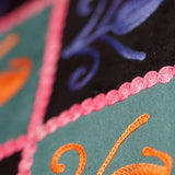 Unique style purse with cashmere handwork embroidery that comes with a wristlet and a secure zip top closure.