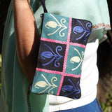 Unique style purse with cashmere handwork embroidery that comes with a wristlet and a secure zip top closure.