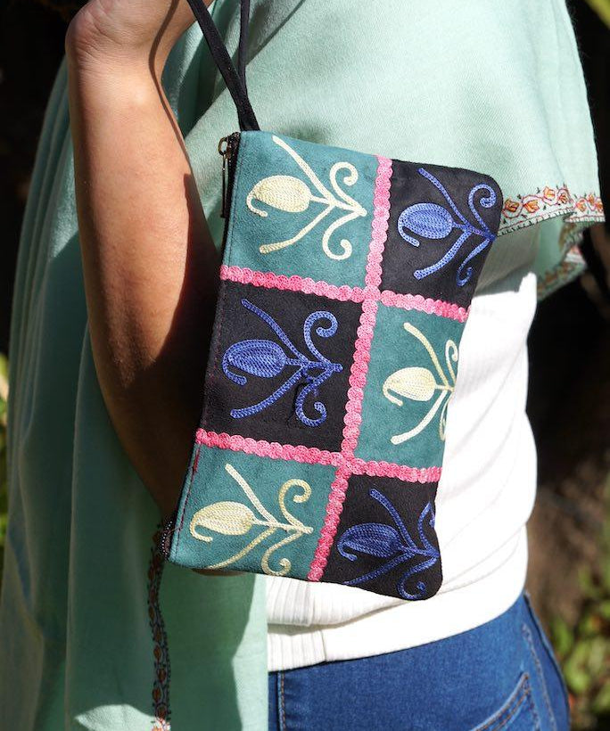 Unique style purse with cashmere handwork embroidery that comes with a wristlet and a secure zip top closure.