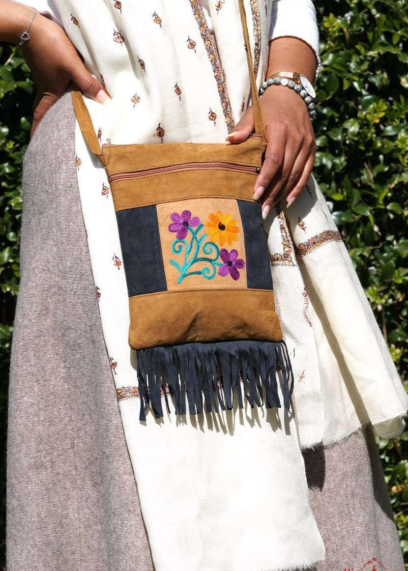 Easy to carry side bag for women, features a beautiful hand embroidered floral pattern. 