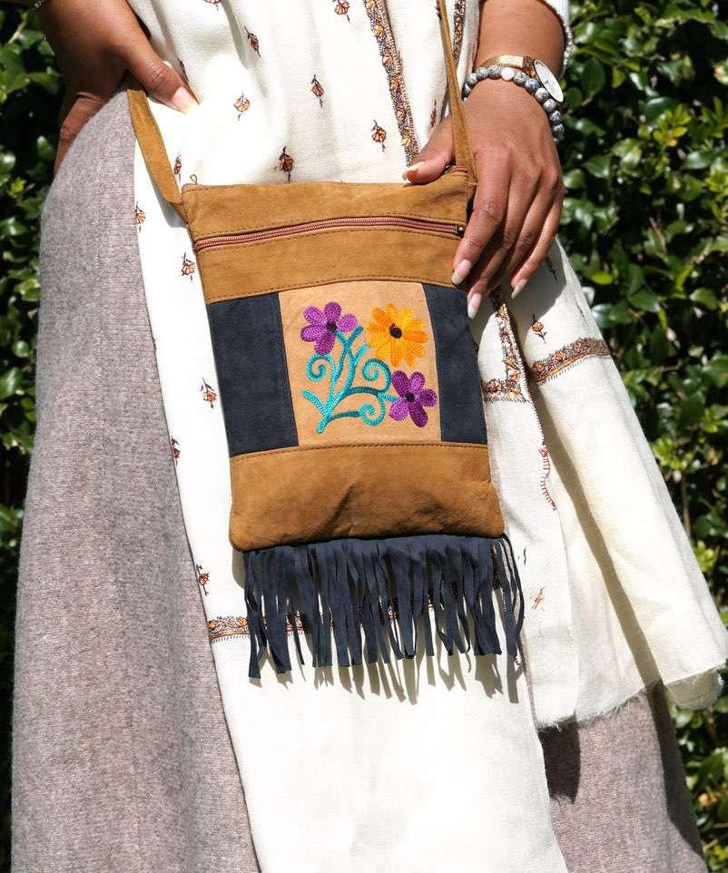Easy to carry side bag for women, features a beautiful hand embroidered floral pattern. 
