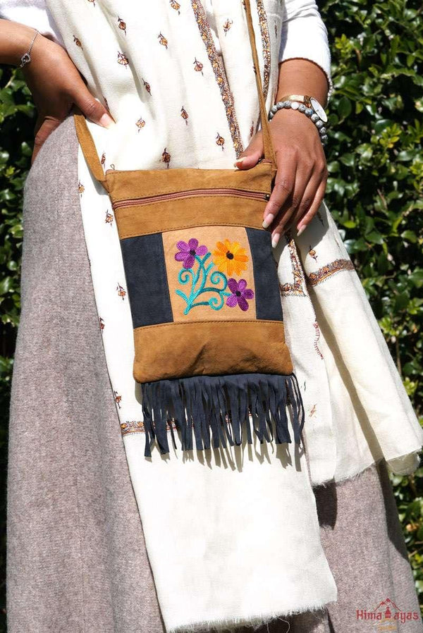 Easy to carry side bag for women, features a beautiful hand embroidered floral pattern. 