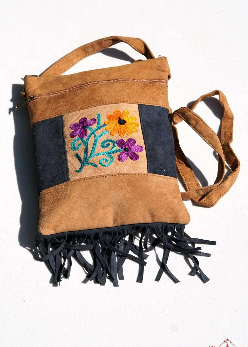Easy to carry side bag for women, features a beautiful hand embroidered floral pattern. 