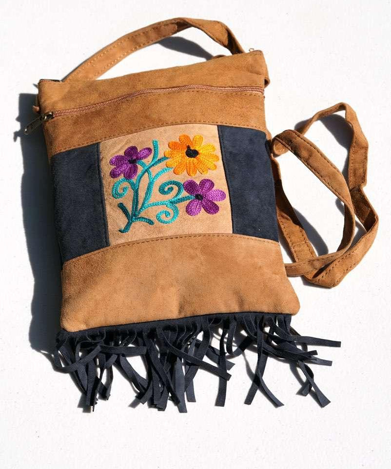 Easy to carry side bag for women, features a beautiful hand embroidered floral pattern. 