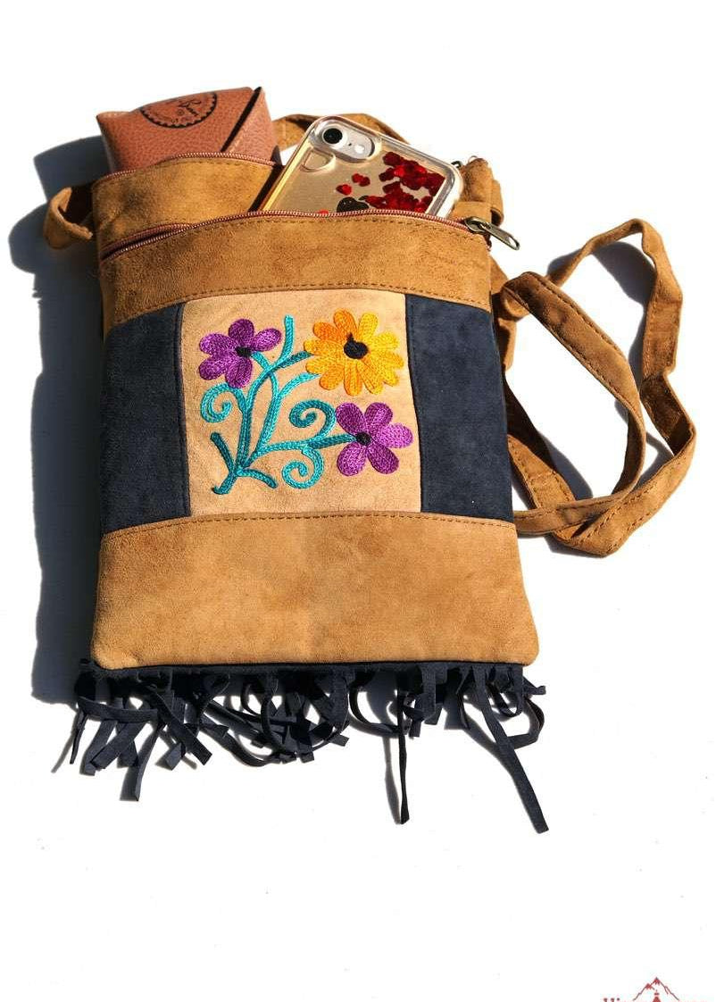 Easy to carry side bag for women, features a beautiful hand embroidered floral pattern. 