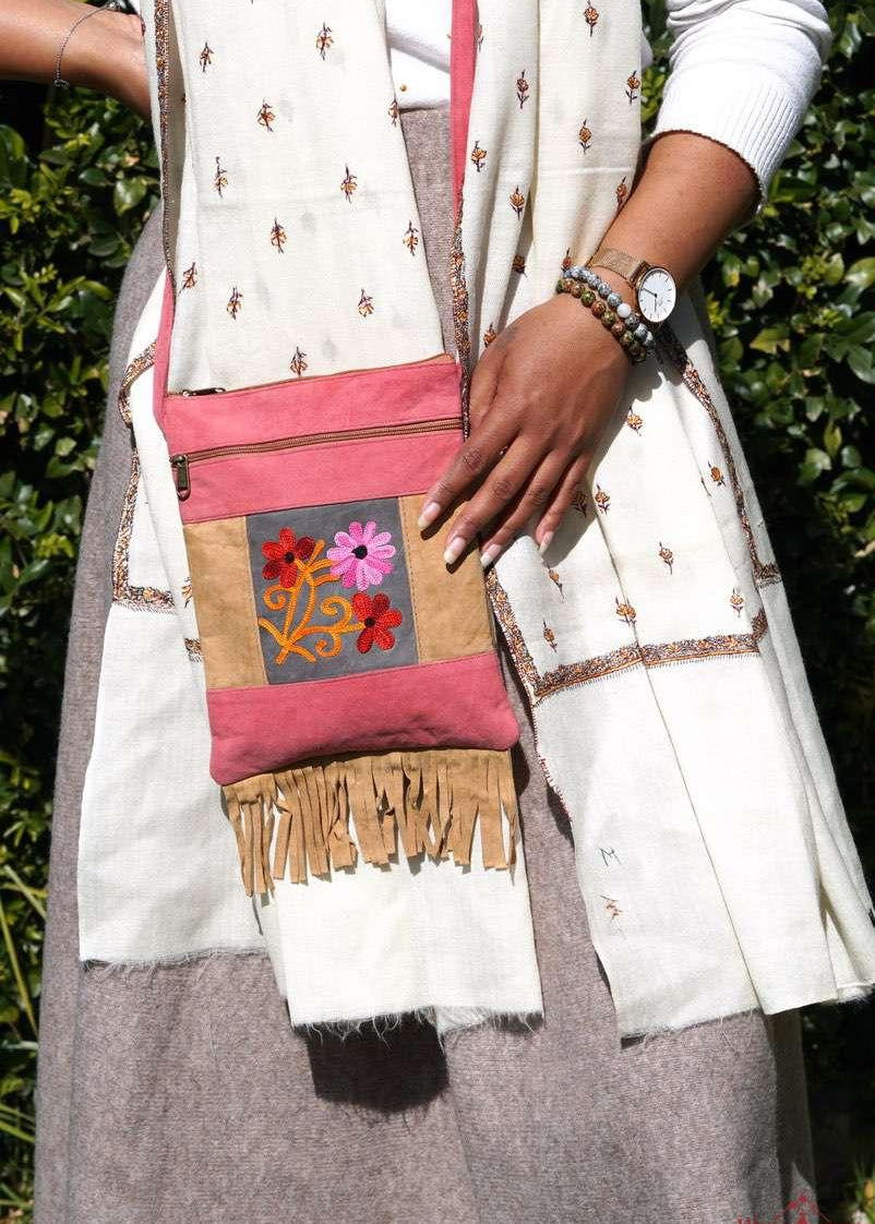 Easy to carry side bag for women, features a beautiful hand embroidered floral pattern. 