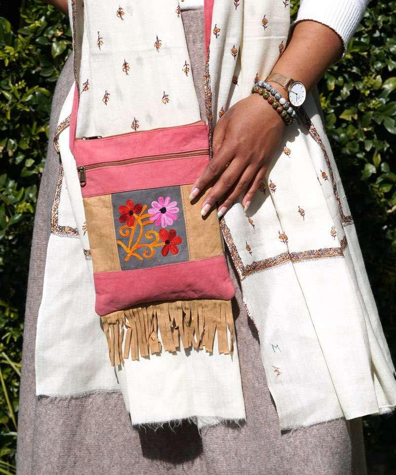 Easy to carry side bag for women, features a beautiful hand embroidered floral pattern. 