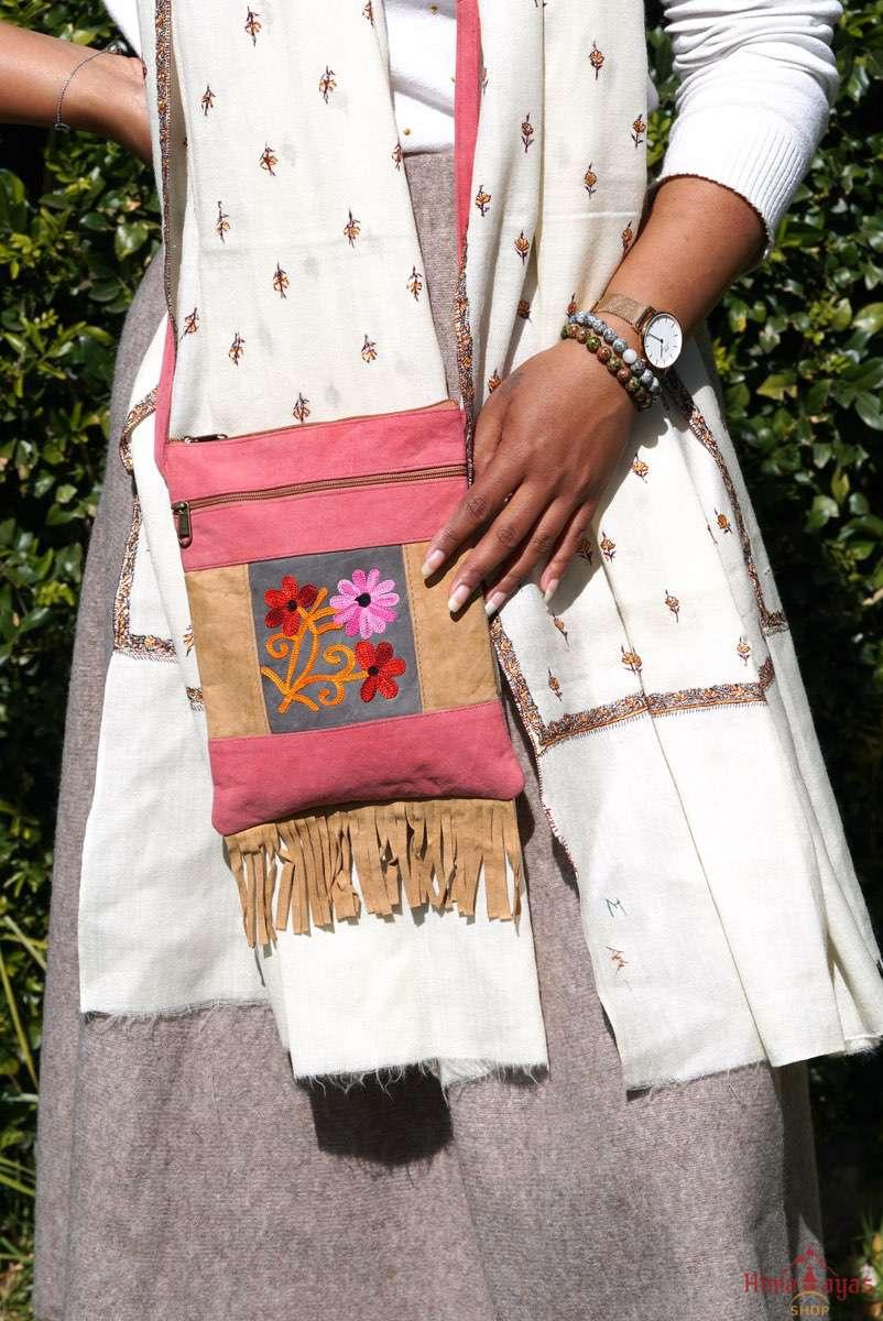 Easy to carry side bag for women, features a beautiful hand embroidered floral pattern. 