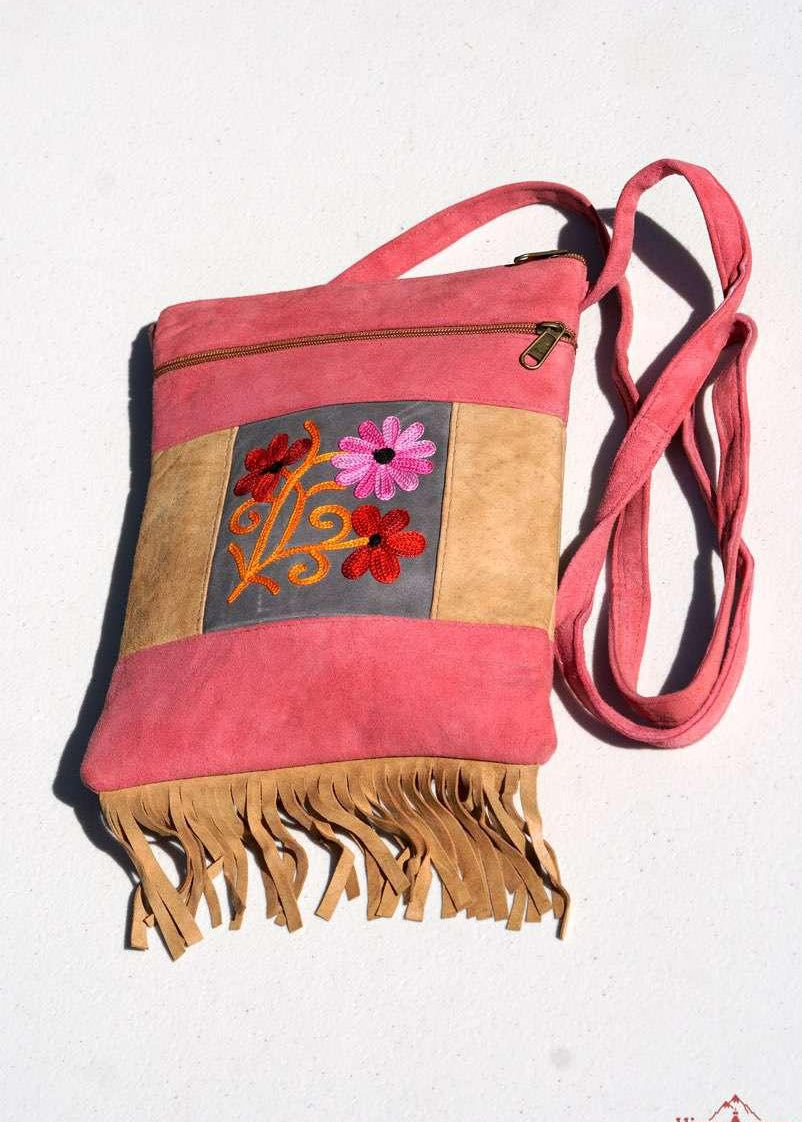 Easy to carry side bag for women, features a beautiful hand embroidered floral pattern. 