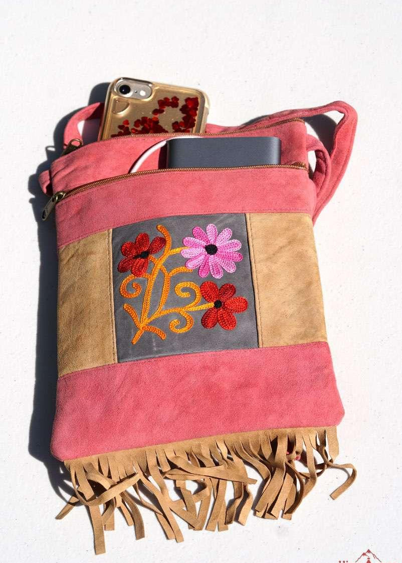 Easy to carry side bag for women, features a beautiful hand embroidered floral pattern. 