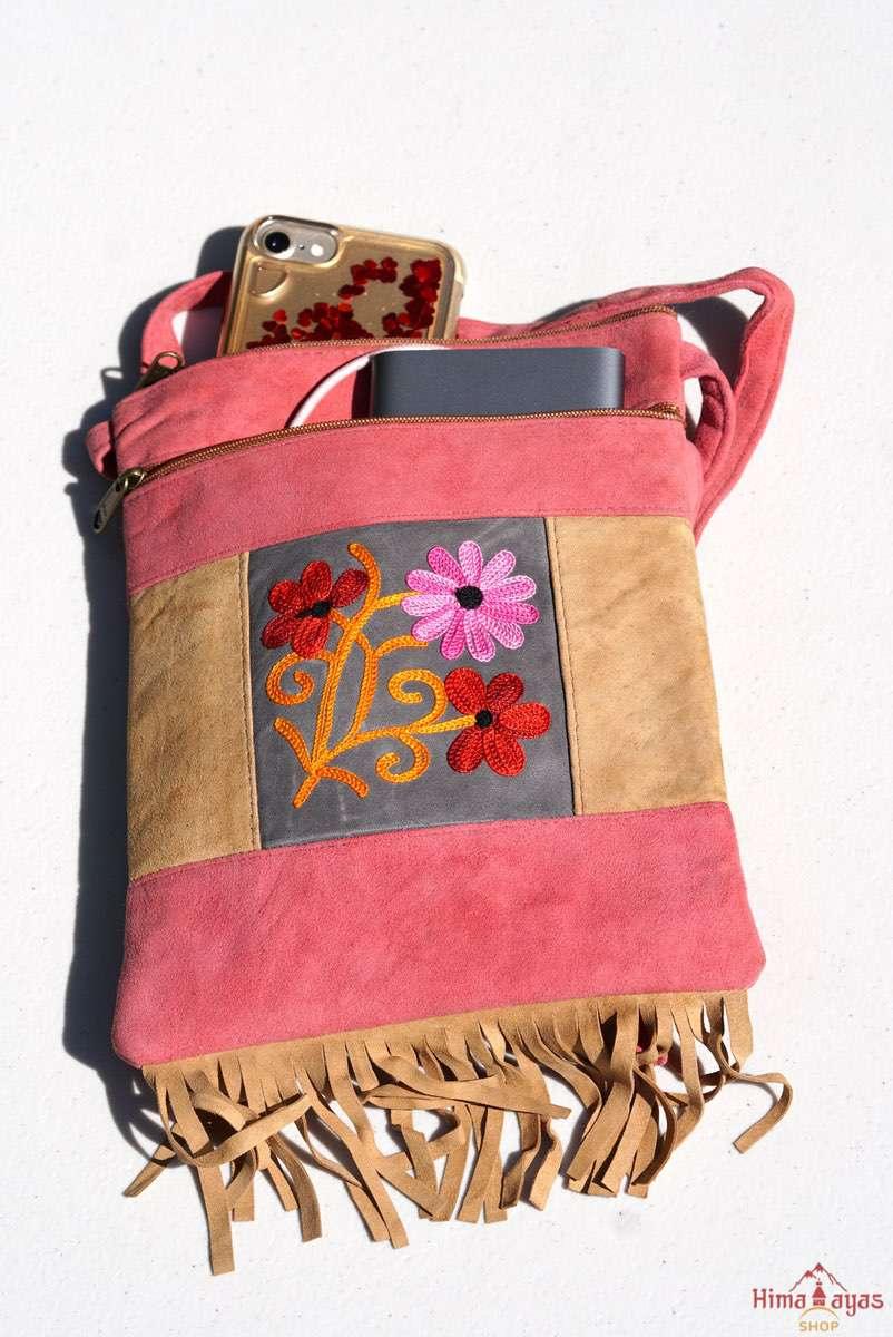 Easy to carry side bag for women, features a beautiful hand embroidered floral pattern. 