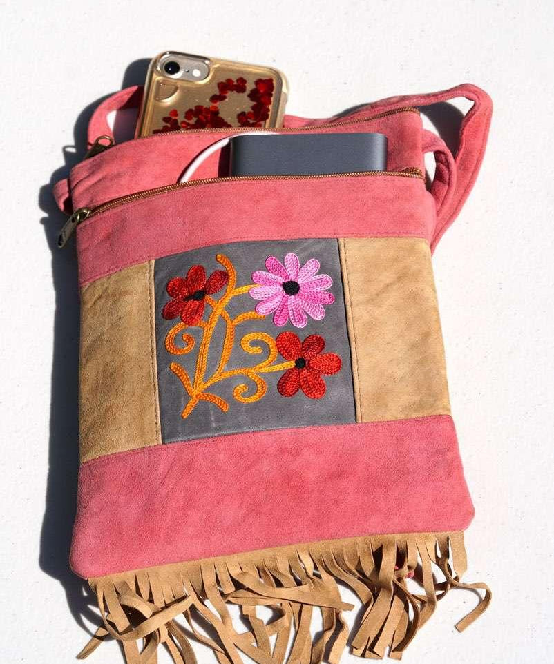 Easy to carry side bag for women, features a beautiful hand embroidered floral pattern. 