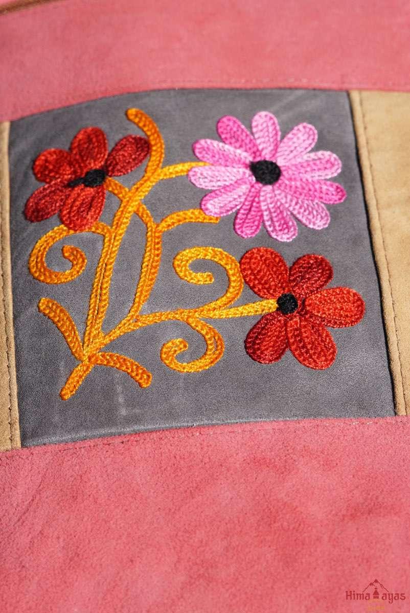 Easy to carry side bag for women, features a beautiful hand embroidered floral pattern. 