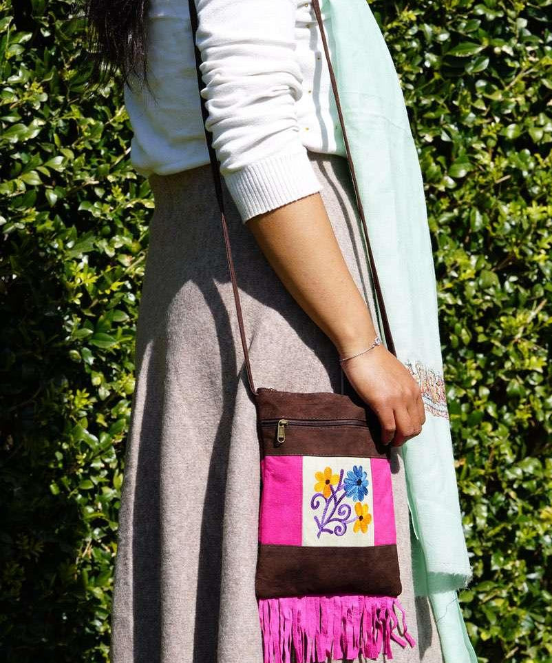Easy to carry side bag for women, features a beautiful hand embroidered floral pattern. 