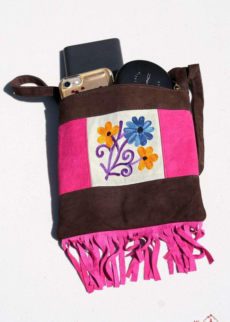 Easy to carry side bag for women, features a beautiful hand embroidered floral pattern. 