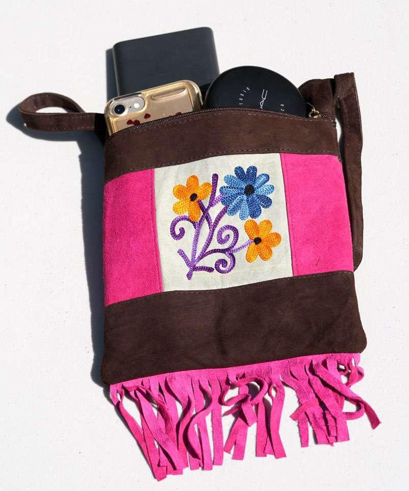Easy to carry side bag for women, features a beautiful hand embroidered floral pattern. 