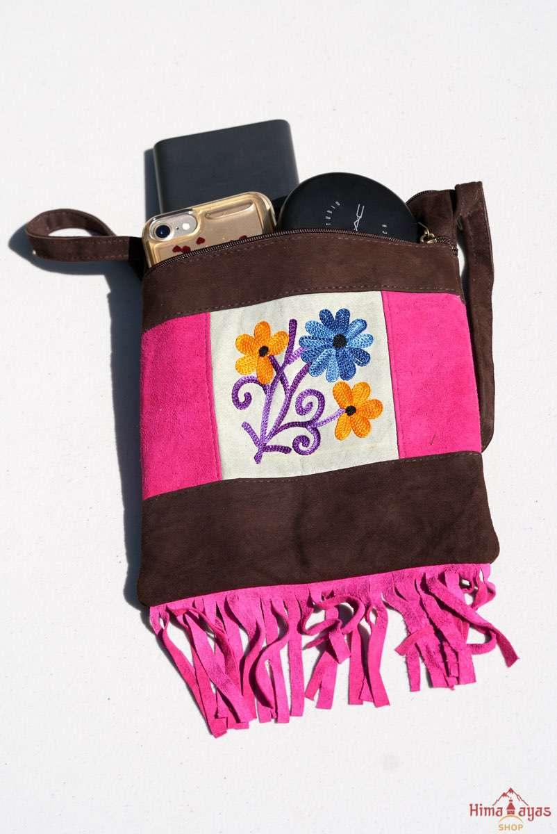 Easy to carry side bag for women, features a beautiful hand embroidered floral pattern. 