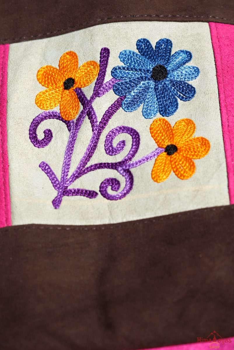 Easy to carry side bag for women, features a beautiful hand embroidered floral pattern. 