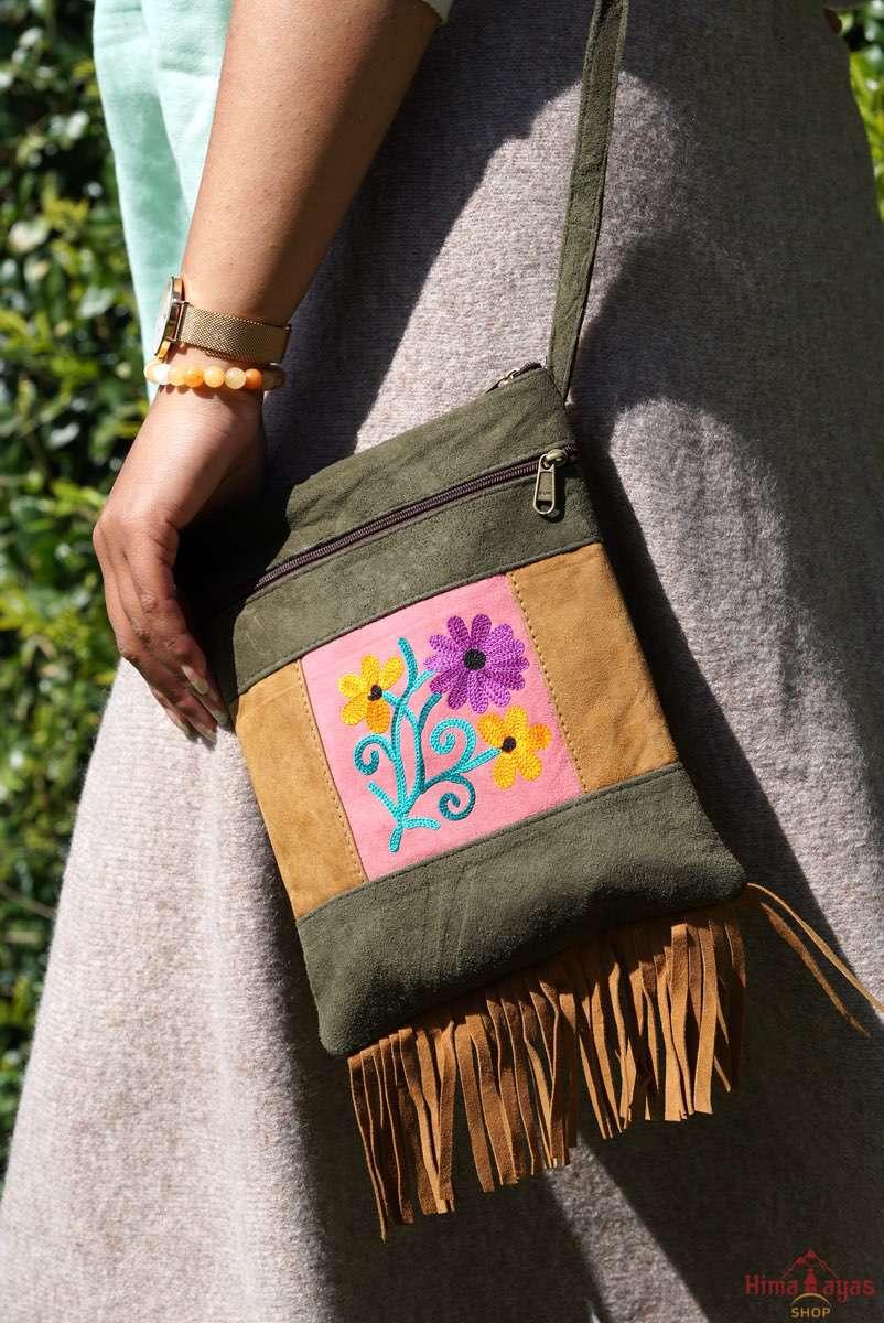 Easy to carry side bag for women, features a beautiful hand embroidered floral pattern. 