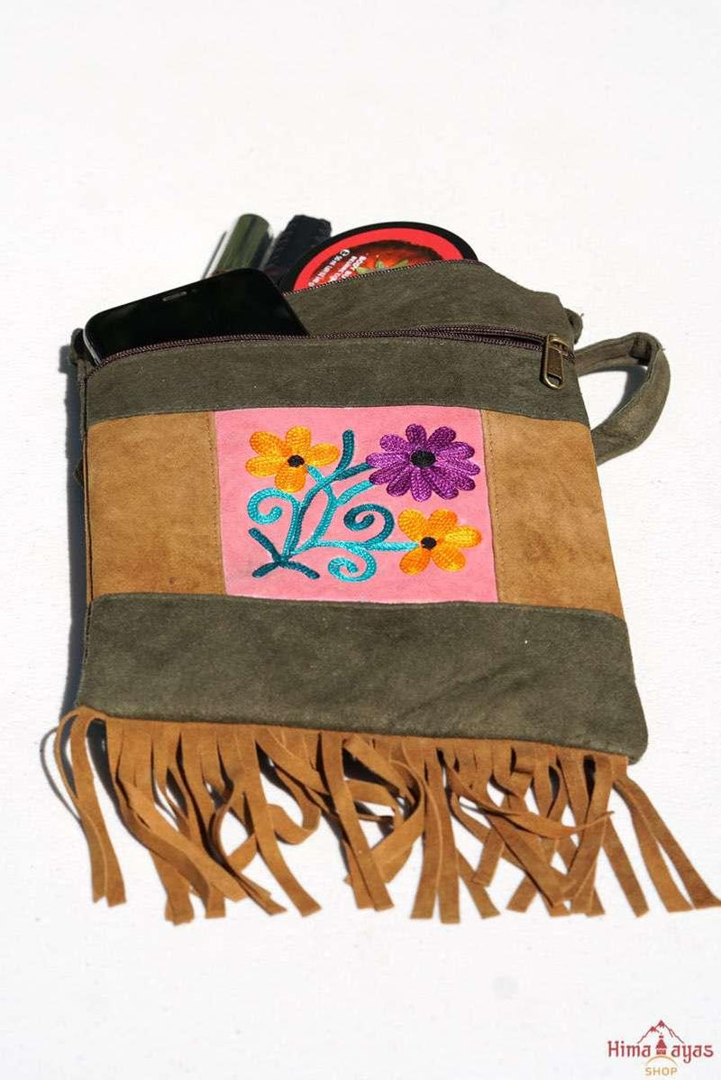 Easy to carry side bag for women, features a beautiful hand embroidered floral pattern. 