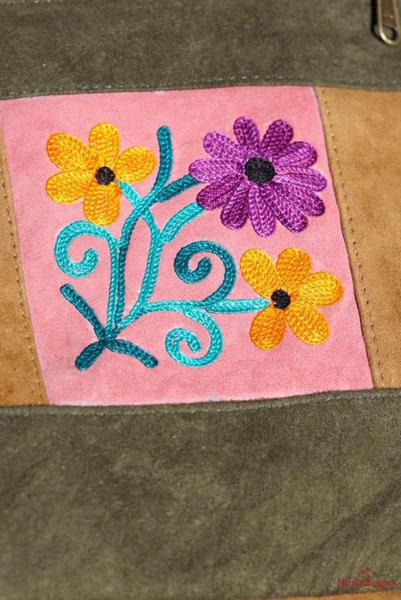 Easy to carry side bag for women, features a beautiful hand embroidered floral pattern. 