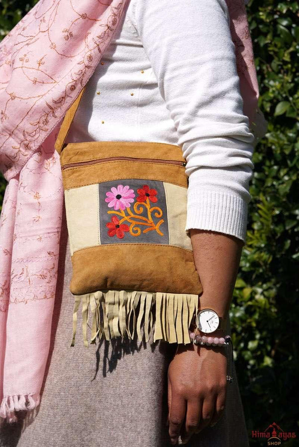 Easy to carry side bag for women, features a beautiful hand embroidered floral pattern. 