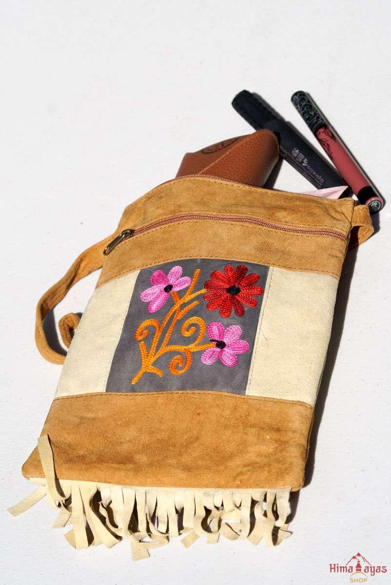Easy to carry side bag for women, features a beautiful hand embroidered floral pattern. 