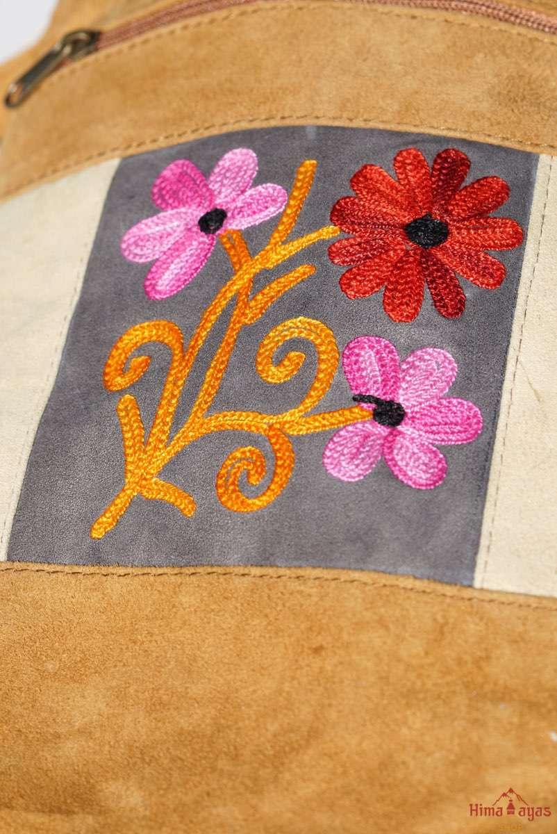 Easy to carry side bag for women, features a beautiful hand embroidered floral pattern. 