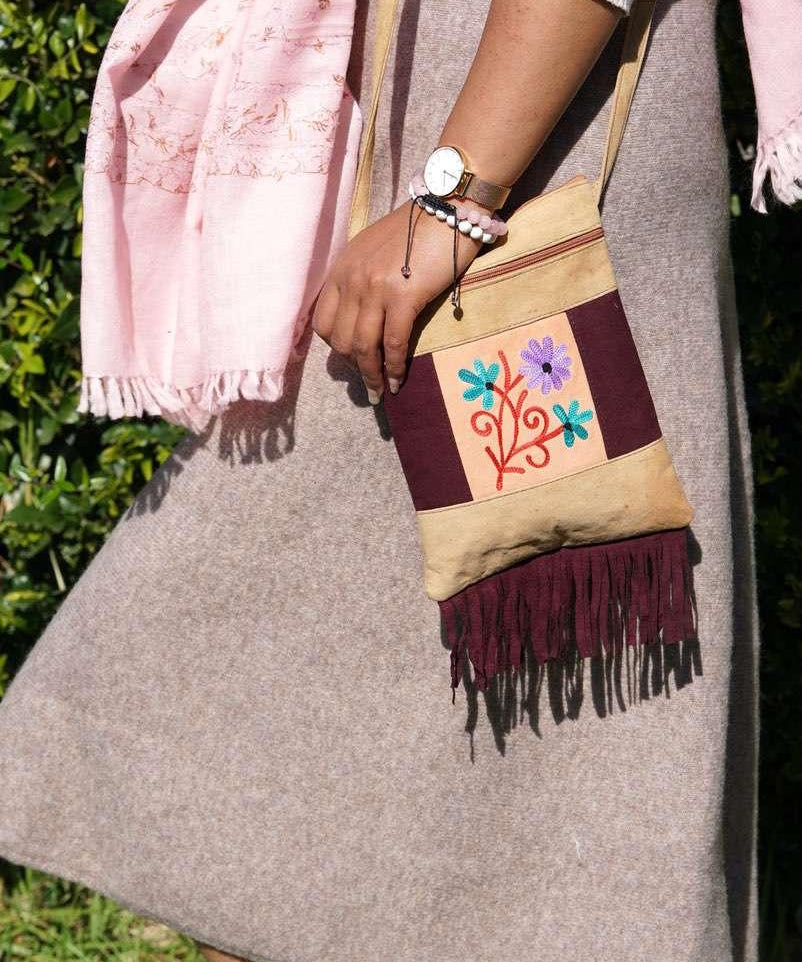 Easy to carry side bag for women, features a beautiful hand embroidered floral pattern. 