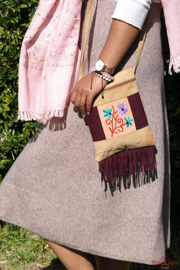 Easy to carry side bag for women, features a beautiful hand embroidered floral pattern. 