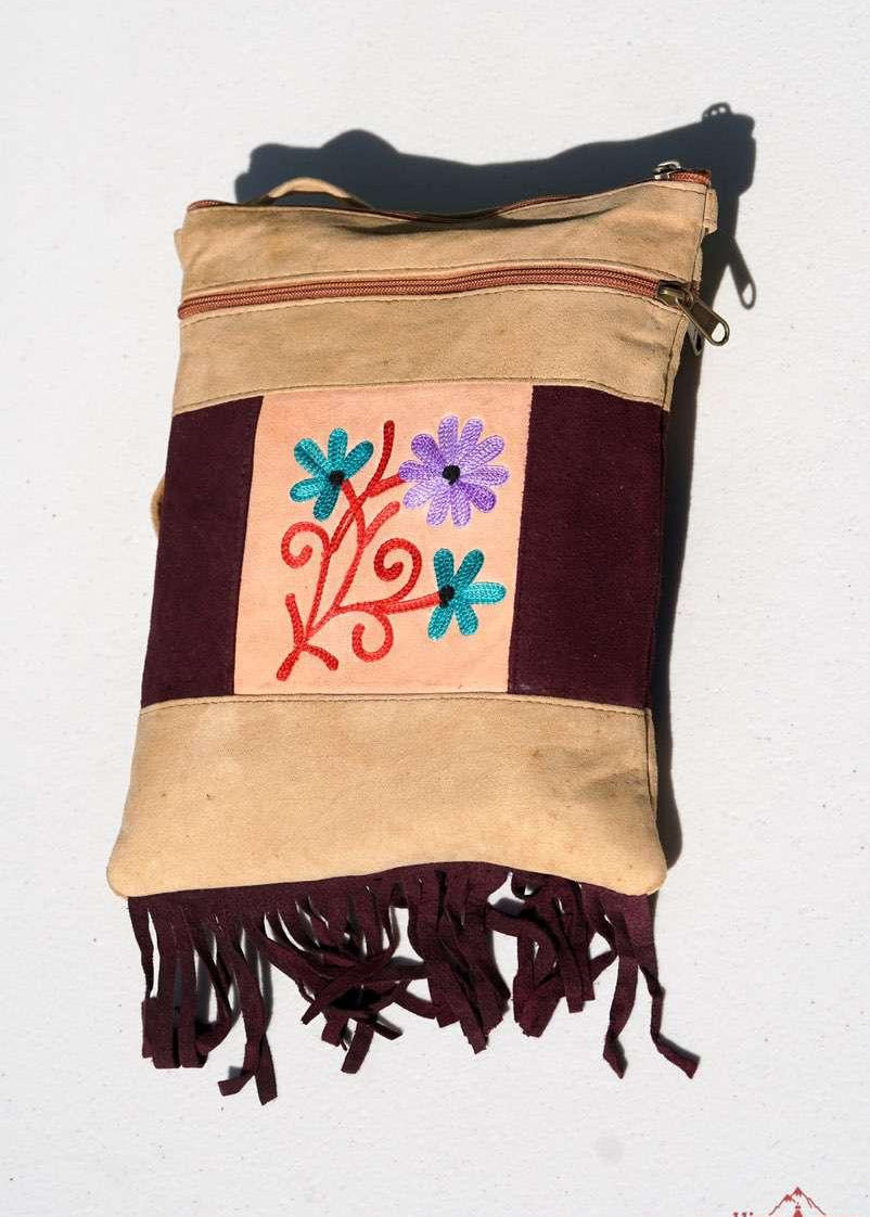 Easy to carry side bag for women, features a beautiful hand embroidered floral pattern. 