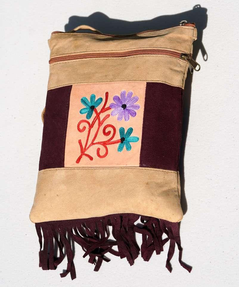 Easy to carry side bag for women, features a beautiful hand embroidered floral pattern. 