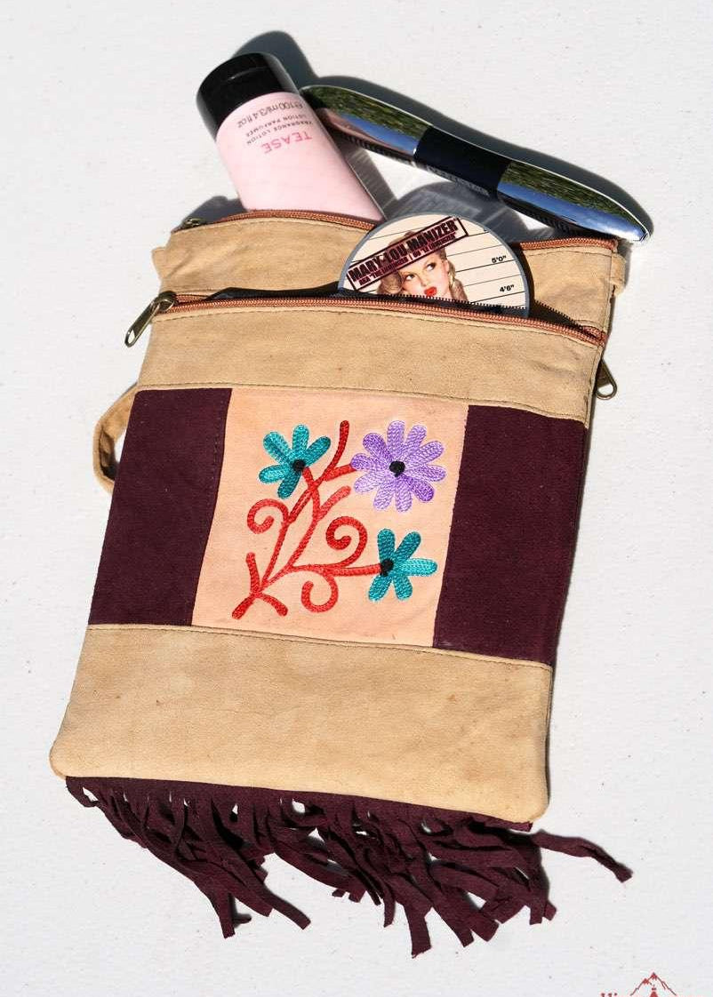 Easy to carry side bag for women, features a beautiful hand embroidered floral pattern. 