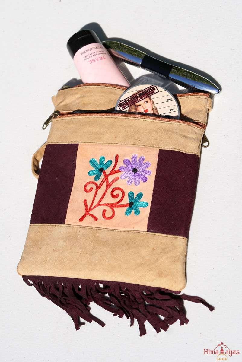 Easy to carry side bag for women, features a beautiful hand embroidered floral pattern. 