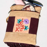 Easy to carry side bag for women, features a beautiful hand embroidered floral pattern. 