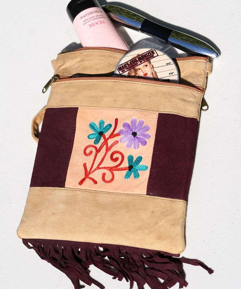 Easy to carry side bag for women, features a beautiful hand embroidered floral pattern. 