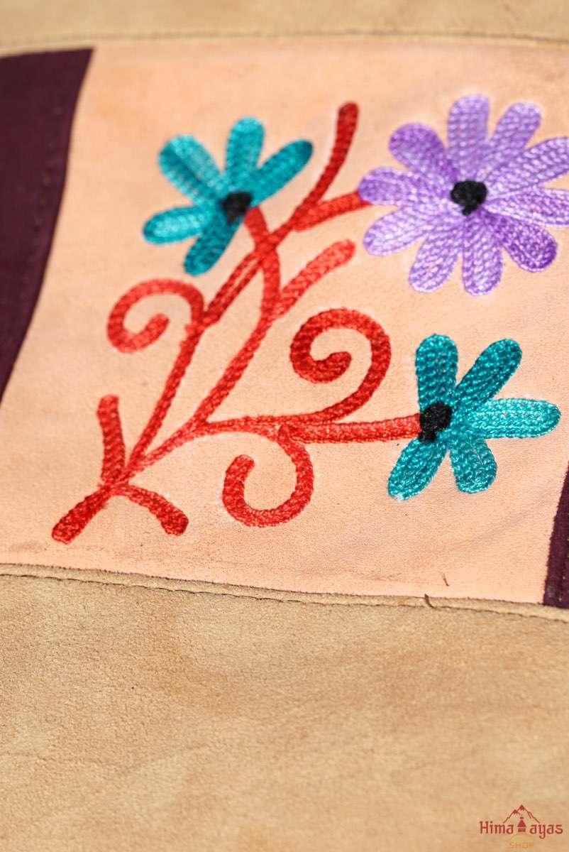 Easy to carry side bag for women, features a beautiful hand embroidered floral pattern. 