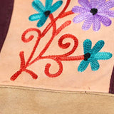 Easy to carry side bag for women, features a beautiful hand embroidered floral pattern. 