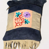 A small sling style, cross body bag with tassel/fringe at the bottom giving it a bohemian chic look.