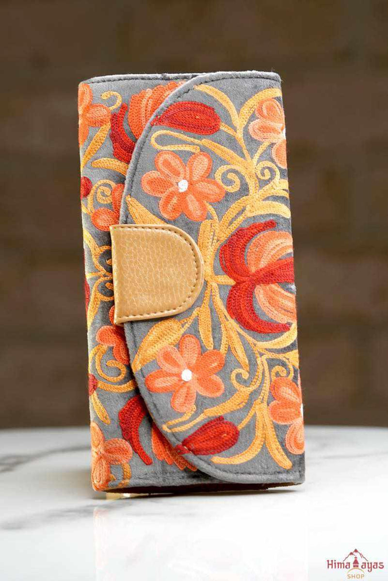 A perfect gift for a chic women, this stylish wallet is hand-embroidered with beautiful crewel work making it a unique statement wallet.